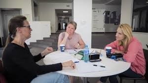 People having a discussion around a table